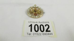 A 9ct gold badge, 8.6 grams, (fastener a/f).