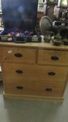 A 2 over 2 pine chest of drawers.