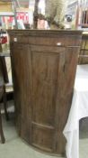 A mahogany dome front corner cupboard.