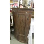 A mahogany dome front corner cupboard.