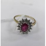 A Diamond and ruby cluster ring in a 9ct gold shank, size N.