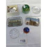 7 glass paperweights including souvenir.