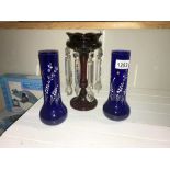 A Victorian ruby glass lustre and a pair of blue glass overlaid vases.