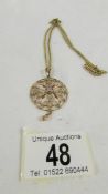 An unmarked yellow metal Edwardian pendant on chains, 9.5 grams.