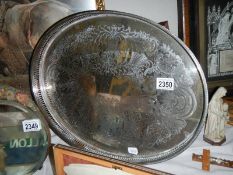 A large oval silver plate gallery tray.