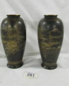 A rare mirror pair of Satsuma baluster porcelain vases in a black matte glaze with gold gilt hand
