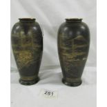 A rare mirror pair of Satsuma baluster porcelain vases in a black matte glaze with gold gilt hand