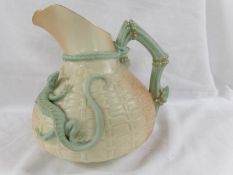 A Royal Worcester jug decorated with applied lizard.