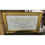 A framed Cadbury sign.