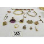 A mixed lot of yellow metal jewellery including bangles, pendants, fobs etc.