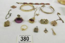 A mixed lot of yellow metal jewellery including bangles, pendants, fobs etc.