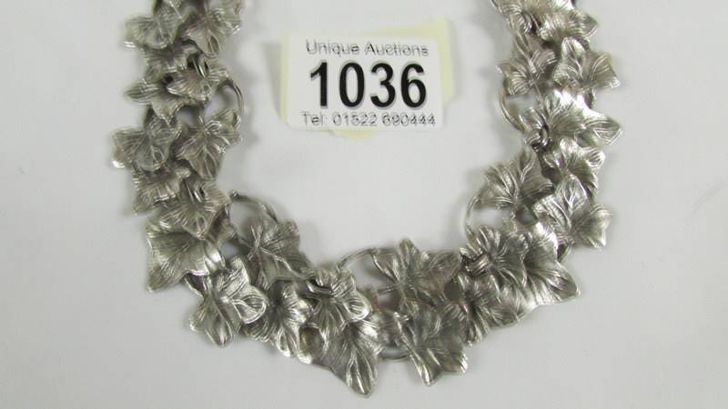 An unusual necklace designed as overlapping leaves in white metal. - Image 2 of 2