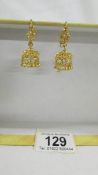 A pair of pendant earrings, (test as 24 ct gold) 8.8 grams.