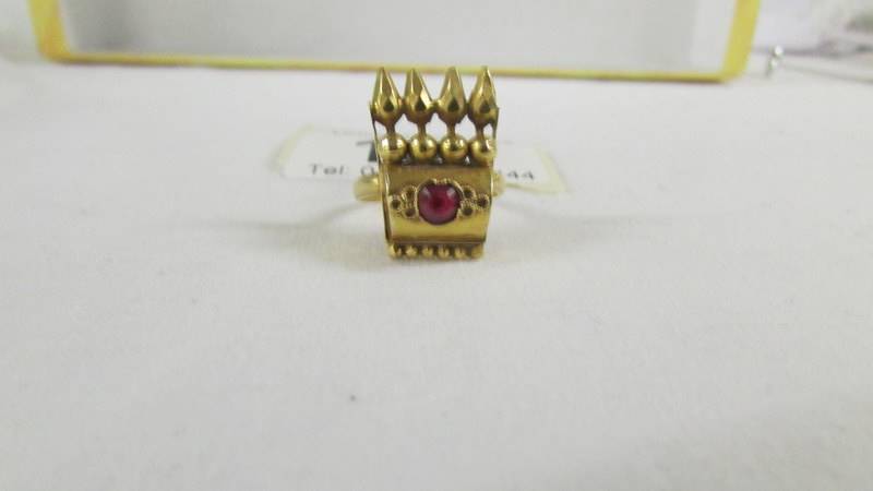 A ring set red stone, size K, (tests as 24ct gold).
