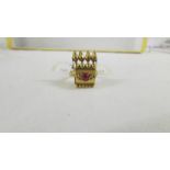 A ring set red stone, size K, (tests as 24ct gold).