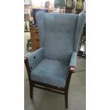 A wing arm chair with reclining action.