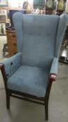 A wing arm chair with reclining action.