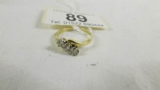 An 18ct yellow gold 3 stone diamond 39pr ring, size M half.