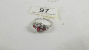 A 14ct gold diamond and ruby ring with raised centre, size S.