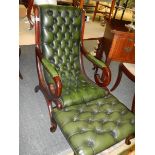 A mahogany framed green leather deep buttoned chair with matching footstool.