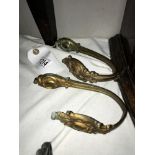 A pair of antique brass curtain tie backs.