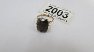 A 9ct gold ring set large red stone (possibly garnet), size L.