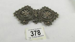 An unusual vintage white metal belt buckle.