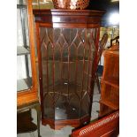 A mahogany astragal glazed corner cabinet.