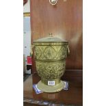 A large lidded brass pot.