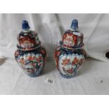 A pair of oriental lidded jars (1 lid a/f).