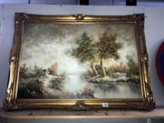 A large gilt framed oil on canvas trees by water.