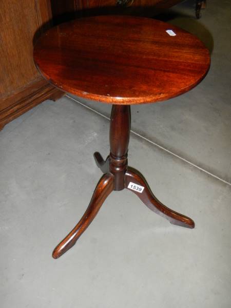 A darkwood stained tripod wine table