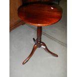 A darkwood stained tripod wine table