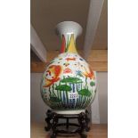 An oriental hand painted vase decorated with Japanese Coi. 50cm tall.