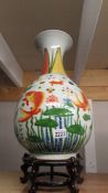 An oriental hand painted vase decorated with Japanese Coi. 50cm tall.