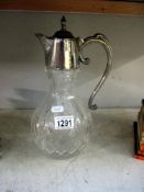 A cut glass claret jug with silver plated fittings