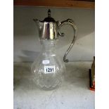 A cut glass claret jug with silver plated fittings
