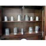 A quantity of pewter tankards,