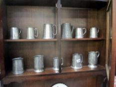 A quantity of pewter tankards,