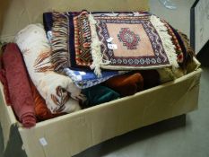 A box of curtaining and fabric pieces plus various rugs and small patchwork quilt.