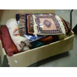 A box of curtaining and fabric pieces plus various rugs and small patchwork quilt.