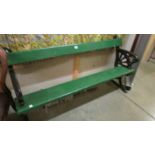 A heavy cast iron and timber bench (painted green and black), 138 cm long,