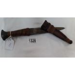 A dagger with leather bound handle and leather sheath
