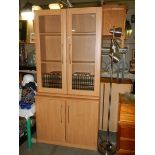 A 2 part office wall unit (glazed bookcase and cabinet).