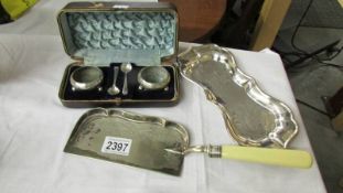 A cased pair of silver plate salts with spoons,