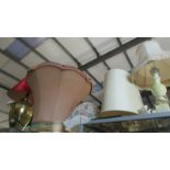 A large brass table lamp, other lamps and lamp shades.