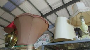 A large brass table lamp, other lamps and lamp shades.