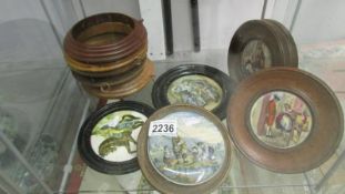 Five framed pot lids and 4 pot lid frames.