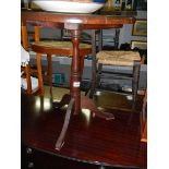 A darkwood stained tripod pub table