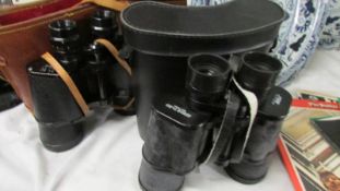 2 cased binoculars - 1 x Omega and 1 x USSR.